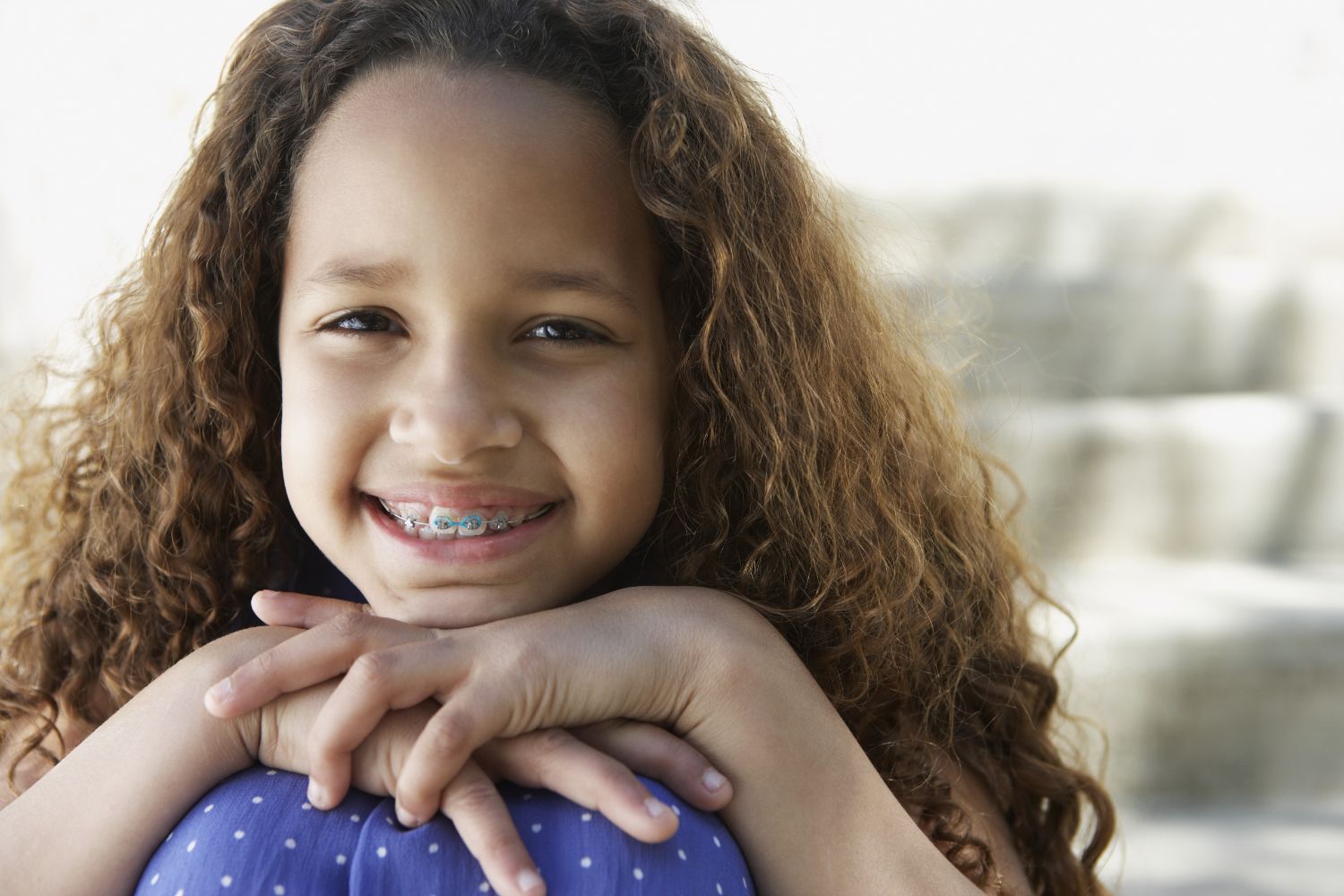 Young girl smiling wearing braces