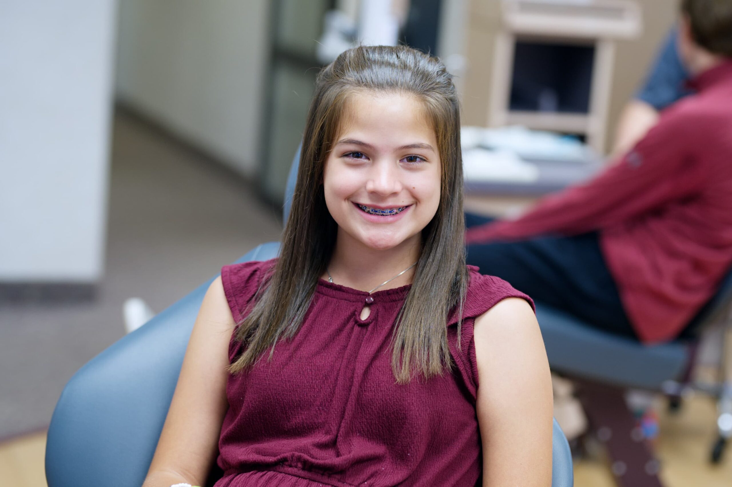 young girl wearing metal braces and smiling